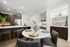 dining room table with dry bar and kitchen counter in background