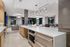 entertaining kitchen with white counters, warming drawers and oven