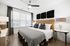 king size bed with nightstands and lamps and dresser and ceiling fan