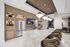 entertaining kitchen with waterfall counter and stainless steel appliances