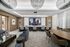 media lounge with HD projection screen and two rows of theater seating and lounge areas