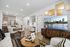 furnished apartment living and dining area with a built in desk and hardwood flooring