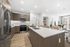 kitchen with stainless steel aplliances and large counter height island with white counters