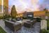 outdoor courtyard with soft lounge seating, fire pit and tvs