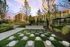 outdoor giant checkerboard with concrete and grass squares surrounded by trees