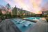 resort style pool with in-pool lounge chairs, surrounded by day beds and sun loungers