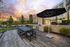 outdoor lounge area with gas grill, chaise loungers, and dining tables
