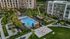 Apartment building with expansive multi-layer courtyard with lush landscaping, outdoor dining and grills