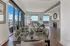 dining area with 6 seater glass top dining table and living area with built-in shelves and fireplace