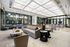 Club room with couches, sofas, bar seating surrounded by windows that look out into the pool courtyard