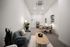office space outfitted with two desks and sofa seating area
