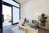 entrance waiting seating area of office space with loveseat and chair and coffee table