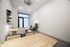 office space outfitted with two desks and sofa seating area