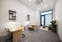 office space outfitted with two desks and sofa seating area