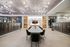 coworking space with 10-seater table, built-in shelves, tv, and mailboxes on either side