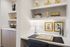 built-in desk with stone desk top and two shelves, next to dry bar with shelves and lower cabinets