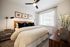 bedroom in apartment with king size bed, nightstands, dresser and ceiling fan