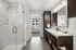 Bathroom with double vanity sink, mirror, cabinetry and standing shower with a glass door