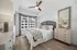 Bedroom with a king size bed, with a dresser besides the bed