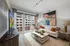 Living room with a TV, sofa sitting and a standing balcony