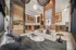 Sitting area inside the mail room with couch, two chairs a coffee table and tv