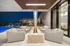 Sofa sitting with centre fireplace besides the pool on the terrace