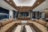 amenity club room in apartment with two sectional sofas in front of kitchen area with counter seats and pendant lighting