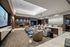 Screening room with projector screen, a variety of lounge, counter. and booth seating