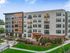Modern apartment complex with stylish exterior, landscaped gardens, and inviting entrance, offering a vibrant community living experience.