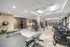 Modern and spacious gym with state-of-the-art equipment, sleek design, and ample lighting.