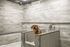Modern pet grooming station in a chic apartment with elegant stone walls and a happy dog enjoying a bath.