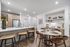 Modern kitchen and dining area with elegant wood finishes, chic lighting, and stylish decor, perfect for entertaining.