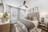 Chic and cozy bedroom with elegant decor, featuring a comfortable bed with patterned cushions, stylish wooden furniture, and soft ambient lighting.