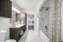 Elegant bathroom with sleek modern fixtures, spacious vanity, and walk-in closet.