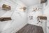 Spacious walk-in closet with elegant wire shelving and natural wood hangers, perfect for modern storage solutions.