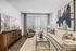 Modern living room with elegant decor, featuring a plush beige sofa, large abstract art, and floor-to-ceiling windows for natural light.