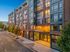 Chic urban apartment building exterior with modern design, large windows, and inviting entrance at twilight.