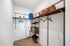 Luxurious walk-in closet with sleek shelving, modern hangers, and elegant storage solutions for a sophisticated lifestyle.