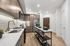 Modern gourmet kitchen with sleek cabinetry, marble backsplash, and spacious island, accented with warm hardwood floors and stainless steel appliances.