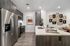 Modern kitchen with sleek stainless steel appliances, elegant cabinetry, and contemporary wall art, offering a sophisticated and inviting atmosphere.