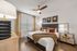Elegant bedroom featuring a modern design with a cozy bed, stylish accessories, and warm lighting.
