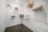 Spacious walk-in closet with sleek wire shelving, wooden hangers, and stylish storage baskets, offering ample organization space.