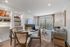 Elegant living area with natural light, featuring a cozy sofa, stylish dining table, and modern decor, perfect for a welcoming home atmosphere.
