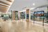 Luxurious and modern gym with state-of-the-art equipment, mirrored walls, and bright lighting, perfect for fitness enthusiasts.