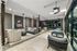 Luxurious open-air lounge area featuring modern seating, stylish ceiling fans, and a beautiful view of landscaped gardens.