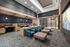 Modern communal lounge featuring plush seating, stylish decor, and a large projection screen, perfect for social gatherings.