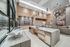 Luxurious open-concept living area featuring a modern kitchen island, elegant lighting, and cozy seating, perfect for entertaining.