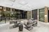 Contemporary lobby lounge with modern seating, sleek design, and large floor-to-ceiling windows providing a view of the urban landscape.