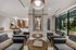 Elegant apartment lobby with chic seating, modern lighting, and a sophisticated marble centerpiece offering a luxurious ambiance.