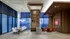 Sophisticated modern apartment interior with breathtaking floor-to-ceiling windows, elegant dining area, and cozy seating with a city view.